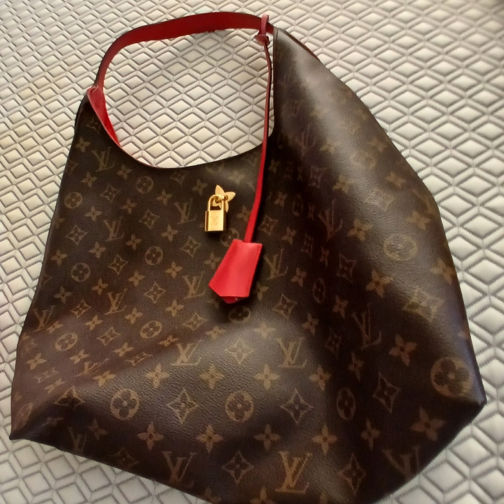 Authentic LV RARE RED ACCENTS FOB.like new. Flower Hobo bag.